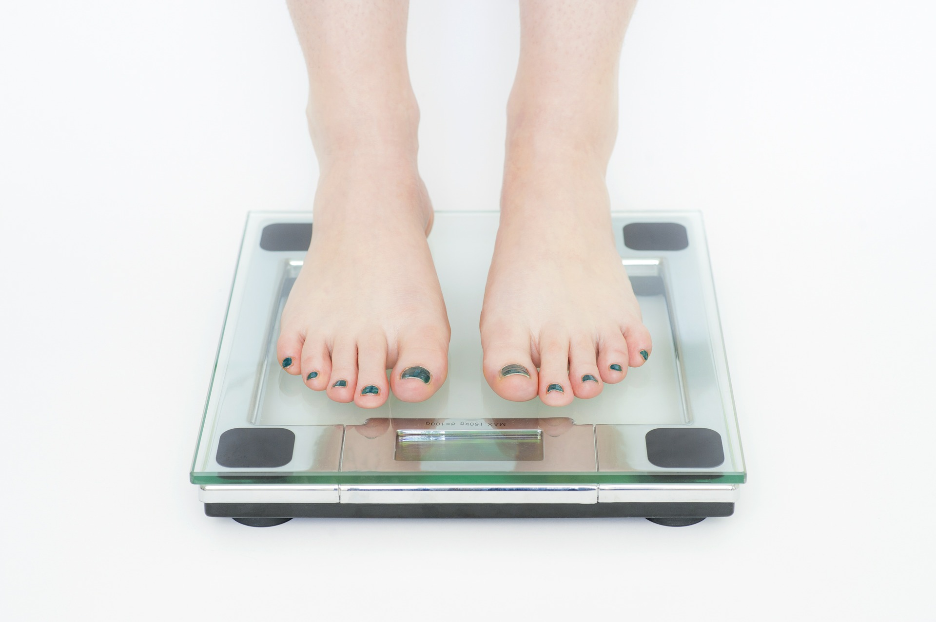 Fat shaming person on scale